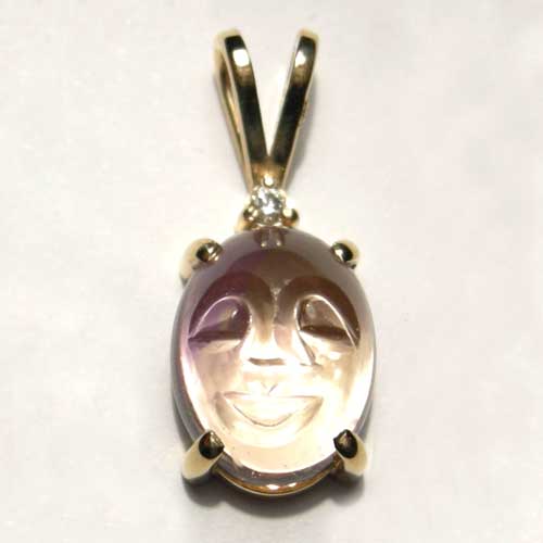 gold oval carved Amatrine and diamond pendant