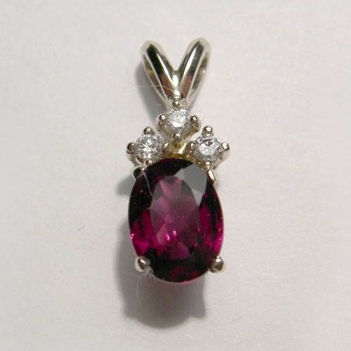 gold oval shaped garnet and diamond pendant