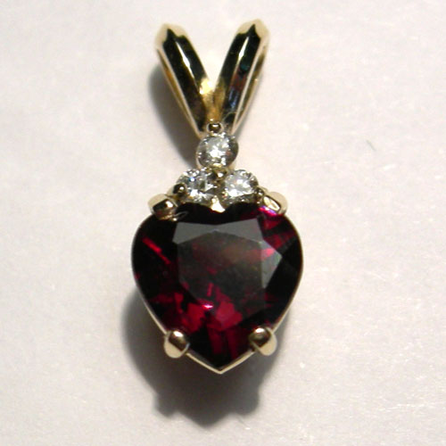 gold heart shaped garnet and diamond pendant