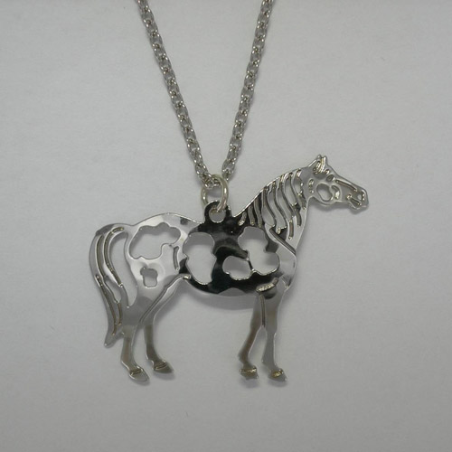Close up of Pinto Horse pendant of necklace