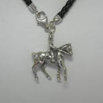 Close of of right side of horse and rider charm