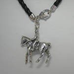close up of left side of rider and horse charm