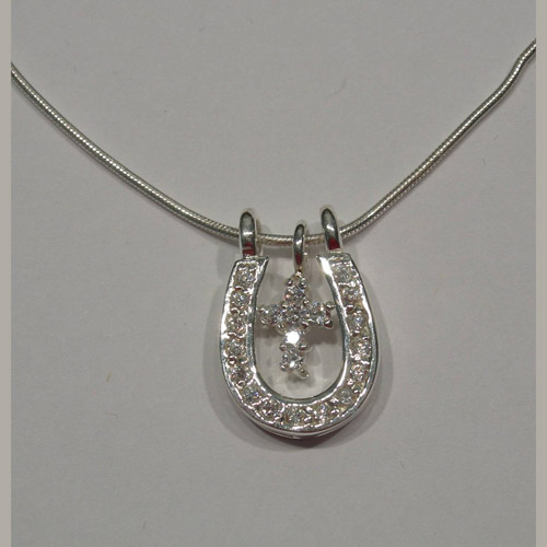 close up of C Z cross and horseshoe necklace