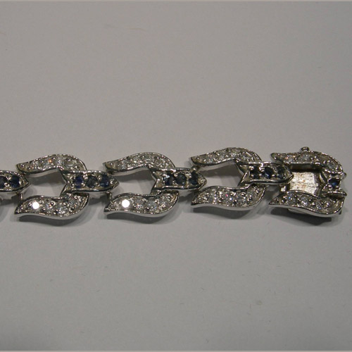 slot side of clasp of sapphire and Cubic Zirconia horseshoe bracelet