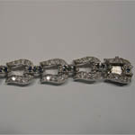 slot side of clasp of sapphire and Cubic Zirconia horseshoe bracelet