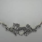 close up of gallolping horse in choker necklace