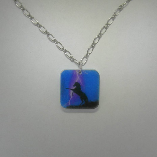 Acrylic rearing black horse in storm necklace.